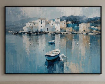 May include: A rectangular wall art print featuring a coastal scene with white buildings along a shoreline, reflected in calm blue water. A small blue and white boat floats in the foreground, with another smaller boat visible in the distance.