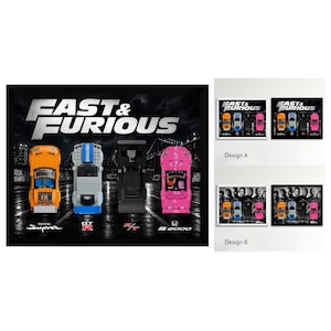 May include: A framed wall art print featuring the Fast & Furious logo above four toy cars: an orange Toyota Supra, a blue and silver GT-R, a black R/T, and a pink S2000. The background shows a dark city street scene with bridge structures.