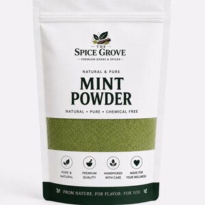 May include: A white stand-up pouch containing green mint powder. The label features the text THE SPICE GROVE, MINT POWDER, NATURAL & PURE, CHEMICAL FREE, and icons representing pure, premium quality, handpicked, and wellness, with a dark green base.