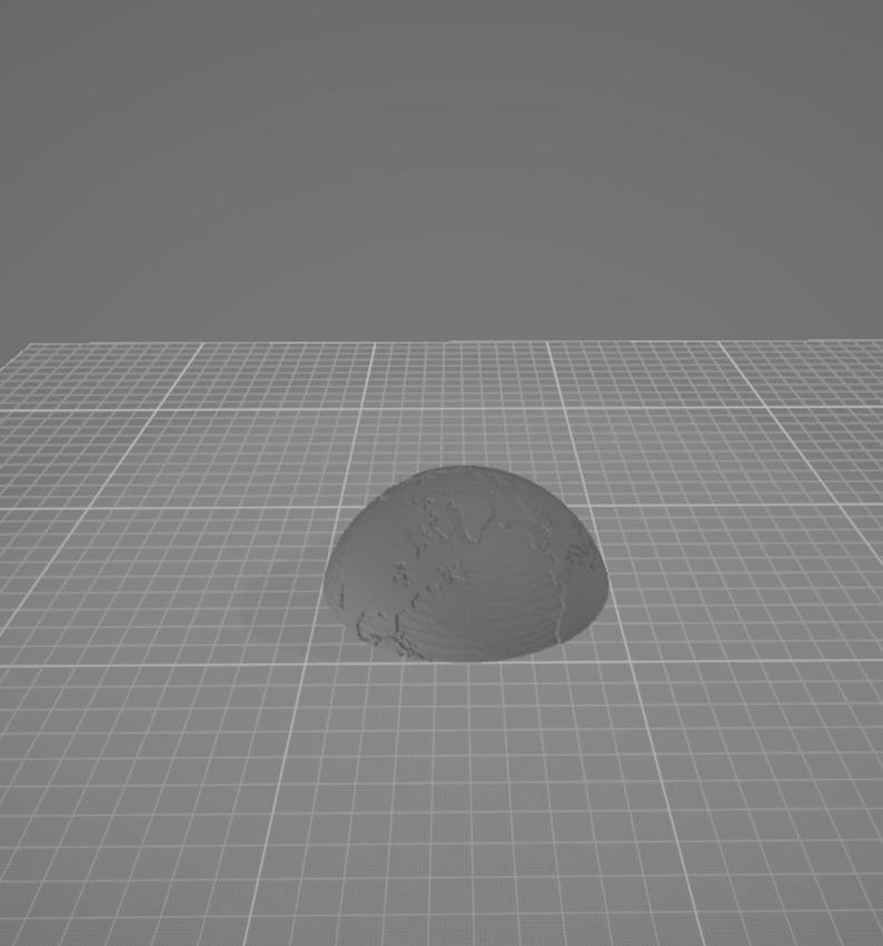May include: A three-dimensional, gray, hemispherical object featuring a textured surface that depicts the continents and oceans of the Earth. The object is rendered with visible horizontal layers, suggesting a 3D printed construction.
