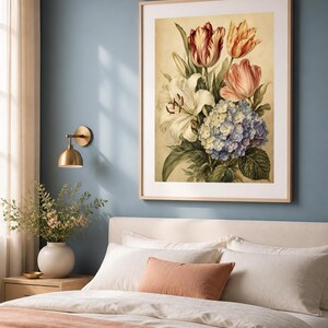 May include: A framed wall art print featuring a botanical illustration of a floral bouquet. The arrangement includes white lilies, red and yellow striped tulips, a pink tulip, and a cluster of blue and white hydrangeas on a cream background.