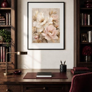 May include: A framed wall art print featuring a botanical illustration of large, layered white and soft pink peony flowers with golden-brown foliage accents, set against a neutral, textured background within a simple black frame.