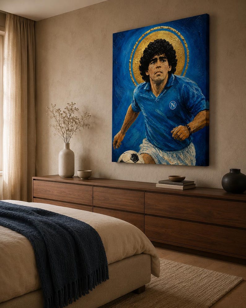 May include: A rectangular canvas wall art print featuring a portrait of a soccer player with curly dark hair, wearing a blue jersey with a white N logo and white shorts, set against a deep blue background with a prominent gold circular halo.