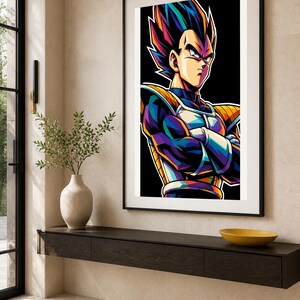 May include: A framed vertical wall art print featuring a stylized illustration of a character with spiky hair, wearing blue and yellow armor with arms crossed. The artwork uses vibrant, high-contrast colors against a solid black background.