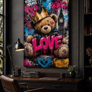 May include: A vertical wall art print featuring a brown teddy bear wearing a gold crown, set against a dark urban background with graffiti elements. The word LOVE is written in large, bright pink 3D letters across the bear's lap. The scene includes a silhouette of Big Ben, blue and pink paint splatters, and the text FOREVER YOURS, KING, and LIVE LOVE LONDON.