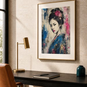 Puede incluir: Una impresi&oacute;n art&iacute;stica enmarcada que muestra el retrato de una persona con el cabello oscuro recogido en un mo&ntilde;o con accesorios florales, vistiendo un kimono azul estampado. La obra incorpora trazos de pintura abstracta azul y rosa y texto japon&eacute;s.