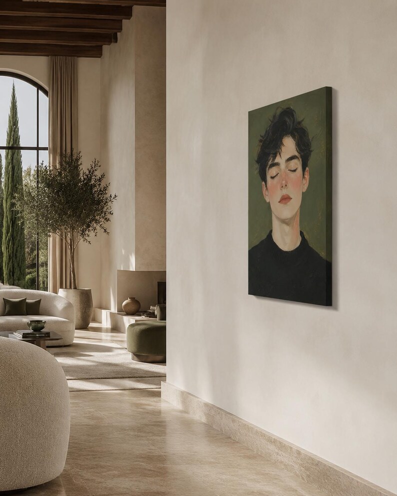 May include: A rectangular canvas wall art print featuring a portrait of a person with dark, messy hair and closed eyes. The subject has a fair complexion with rosy cheeks and wears a black crew-neck shirt against a muted olive green background.