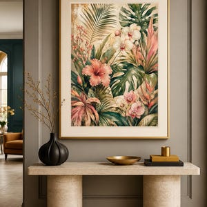 May include: A framed vertical wall art print featuring a lush tropical botanical scene with vibrant pink hibiscus flowers, white orchids, and large green monstera leaves set against a textured, warm-toned background with golden highlights.