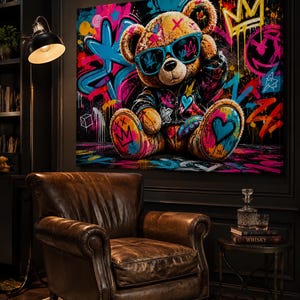 May include: A rectangular canvas wall art print featuring a brown teddy bear wearing a black jacket and blue sunglasses. The bear is surrounded by vibrant graffiti-style street art elements including bright pink, blue, and yellow paint splatters.