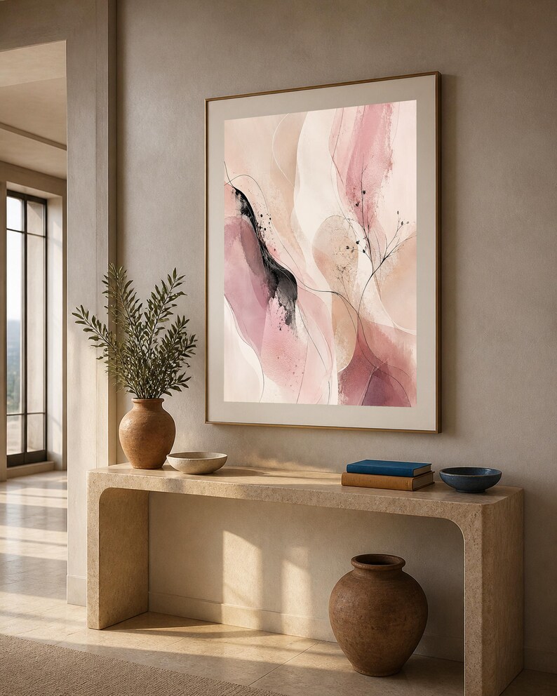 K&ouml;nnte beinhalten: Ein gerahmter vertikaler Wandkunstdruck mit abstrakten Aquarellformen in Altrosa, zartem Rosa und Creme, akzentuiert durch feine schwarze Tintenlinien und zarte botanische Skizzen, eingefasst in einem d&uuml;nnen, goldfarbenen Metallrahmen.