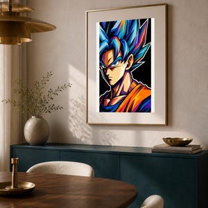 May include: A framed wall art print featuring a stylized illustration of a character with spiky blue hair, sharp facial features, and an orange gi. The artwork uses bold, vibrant colors against a solid black background, presented in a thin frame.