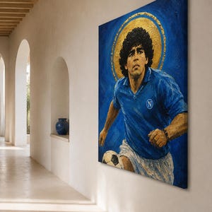 May include: A rectangular canvas painting depicting a soccer player with dark curly hair wearing a blue jersey with a white N logo and white shorts. The player is positioned against a deep blue background with a prominent gold circular halo behind the head.