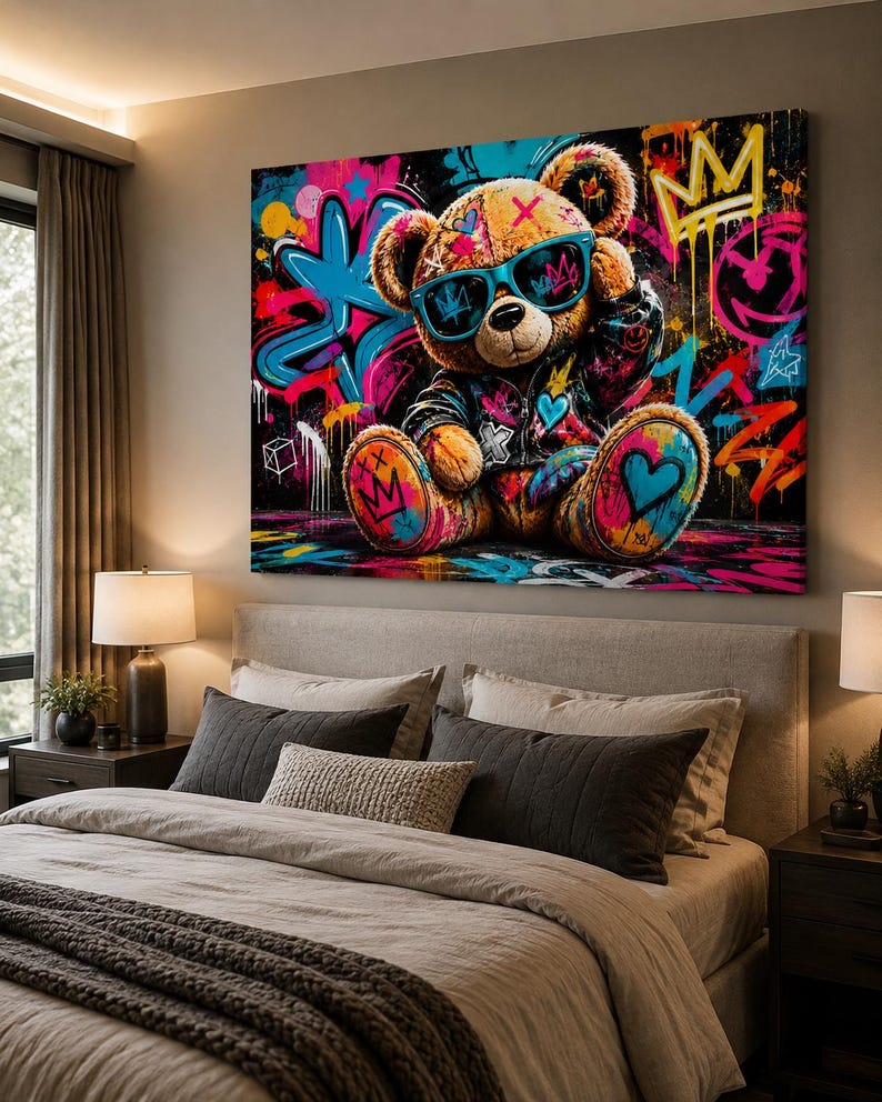 May include: A rectangular wall art canvas featuring a brown teddy bear wearing teal sunglasses and a dark jacket. The bear is set against a vibrant graffiti background with splashes of neon pink, blue, and yellow, including crown and heart motifs.