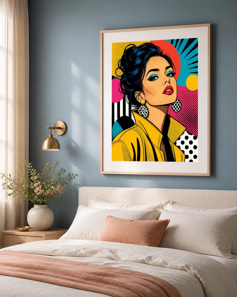 May include: A framed pop art print featuring a stylized illustration of a person with dark hair in an updo, wearing a yellow jacket and large patterned earrings. The background incorporates vibrant colors, geometric shapes, and dot patterns.