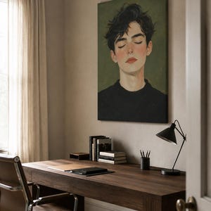 May include: A vertical canvas wall art print featuring a portrait of a person with dark, messy hair and closed eyes, wearing a black sweater against a muted olive green background. The painting style is soft with visible brushstrokes and warm skin tones.