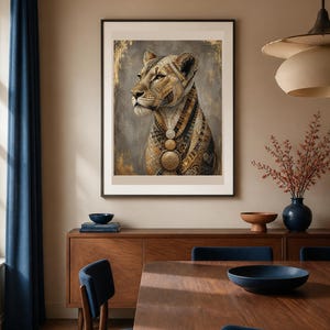 May include: A framed wall art print featuring a stylized lioness portrait. The lioness is rendered in shades of gold, brown, and black with intricate geometric patterns and layered circular medallions around the neck, set against a textured gray background.