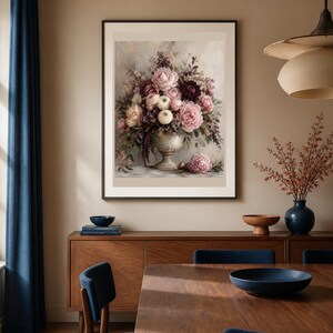 May include: A framed wall art print featuring a detailed floral arrangement in a decorative urn. The bouquet includes various shades of pink, cream, and deep burgundy flowers with green foliage. One flower rests on the surface below the urn.