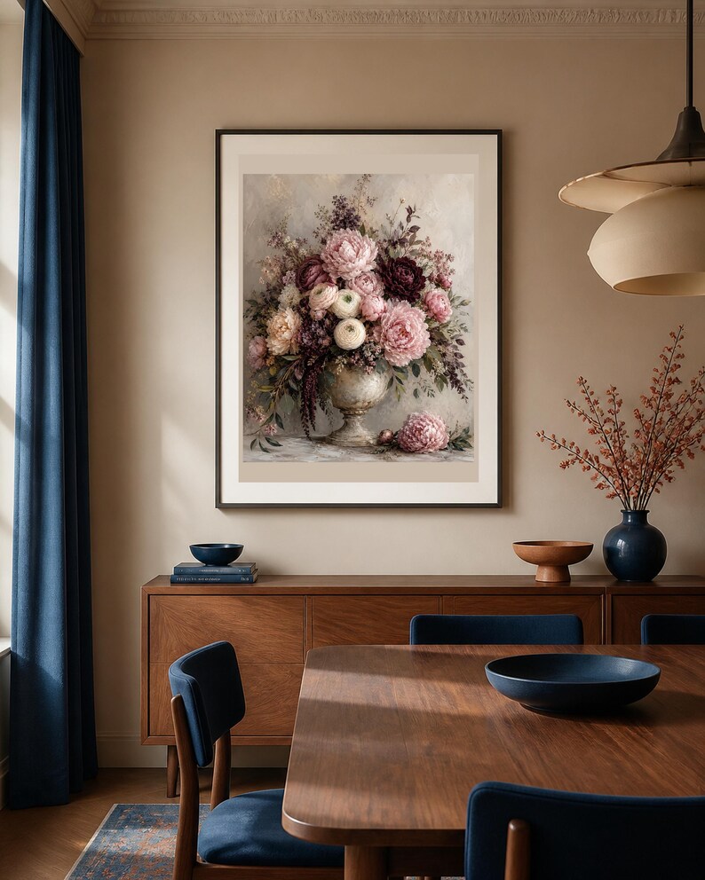 May include: A framed wall art print featuring a detailed floral arrangement in a decorative urn. The bouquet includes various shades of pink, cream, and deep burgundy flowers with green foliage. One flower rests on the surface below the urn.