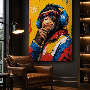 May include: A rectangular wall art print featuring a stylized chimpanzee wearing bright blue headphones, red-rimmed glasses, and a colorful jacket with red, blue, and yellow paint splatters. A white crown icon is painted in the top left corner.