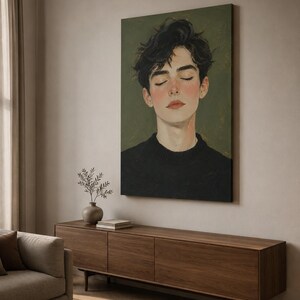 May include: A vertical canvas wall art print featuring a portrait of a person with dark, messy hair and closed eyes. The individual wears a black sweater against a muted olive green background, rendered in a painterly style with soft brushstrokes.
