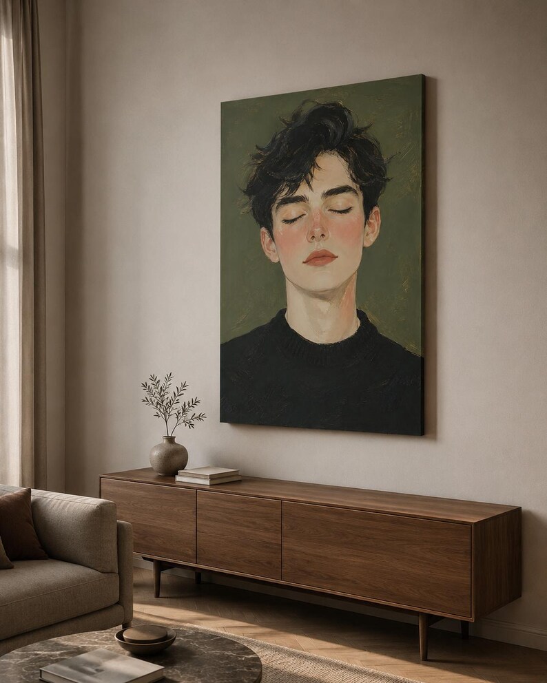 May include: A vertical canvas wall art print featuring a portrait of a person with dark, messy hair and closed eyes. The individual wears a black sweater against a muted olive green background, rendered in a painterly style with soft brushstrokes.