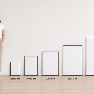 May include: Five rectangular blank white posters in thin black frames, arranged in increasing size from 21x30 cm to 70x100 cm. A reference figure stands next to them, with a vertical dashed line indicating a height of 170 cm for scale.