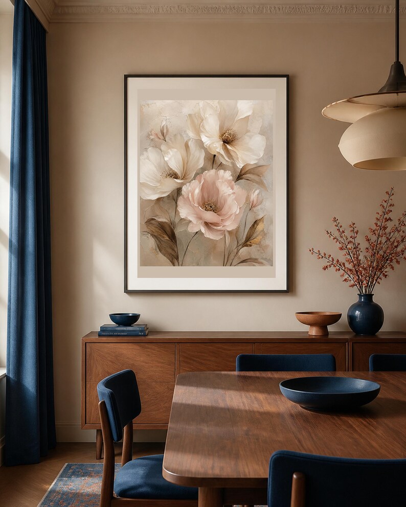 May include: A framed wall art print featuring a soft-toned botanical illustration of three large, layered flowers in shades of cream, beige, and pale pink, set against a muted, textured background with delicate brown foliage accents.