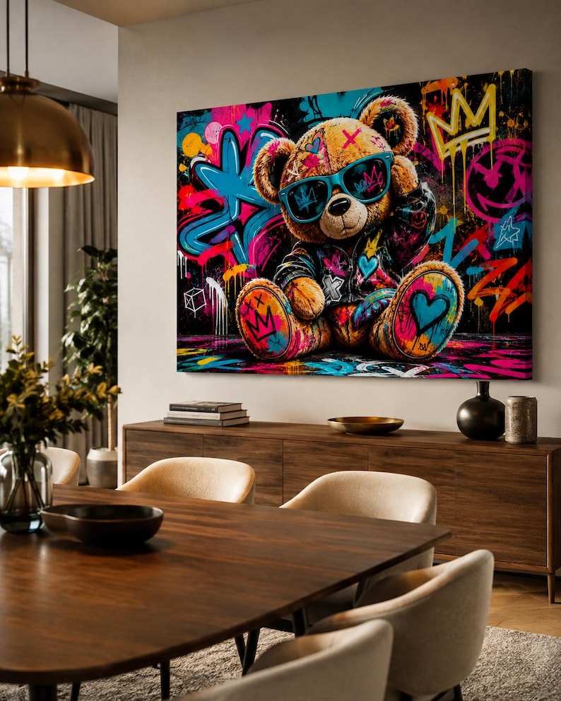 May include: A rectangular wall art canvas featuring a brown teddy bear wearing a black jacket and bright blue sunglasses. The background is a vibrant graffiti mural with neon pink, blue, and yellow paint splatters, crowns, and heart symbols.