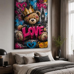 May include: A rectangular wall art print featuring a brown teddy bear wearing a gold crown, positioned in front of a depiction of Big Ben. The artwork includes vibrant graffiti-style elements, the word LOVE in large pink letters, and text.