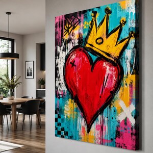 May include: A rectangular canvas wall art piece featuring a large, central red heart topped with a yellow crown. The background is a vibrant, abstract composition of turquoise, black, white, pink, and yellow paint splatters, drips, and geometric marks.