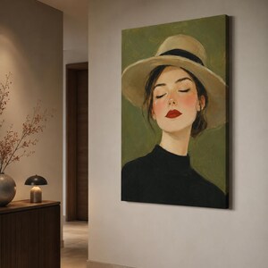 May include: A vertical canvas wall art print featuring an oil painting of a person with closed eyes, wearing a wide-brimmed beige hat with a black band and a black high-neck top. The subject has rosy cheeks and bright red lipstick against a muted olive green background.
