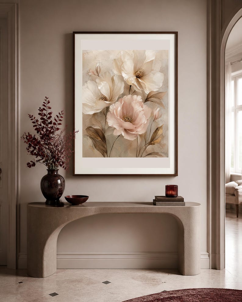 May include: A framed wall art print featuring a soft-toned floral illustration of large, layered petals in shades of cream, beige, and muted pink, set against a neutral background with delicate stems and leaves in earthy brown tones.