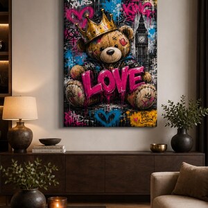 May include: A rectangular wall art print featuring a brown teddy bear wearing a gold crown, set against a dark graffiti-style background with blue and pink accents. The word LOVE is written in large pink letters, with Big Ben visible in the back.