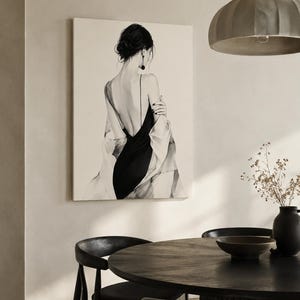 May include: A rectangular wall art print featuring a black and white illustration of a person seen from the back. The figure wears a black dress with thin straps and a low-cut back, draped in a light-colored shawl, with dark hair styled in an updo.