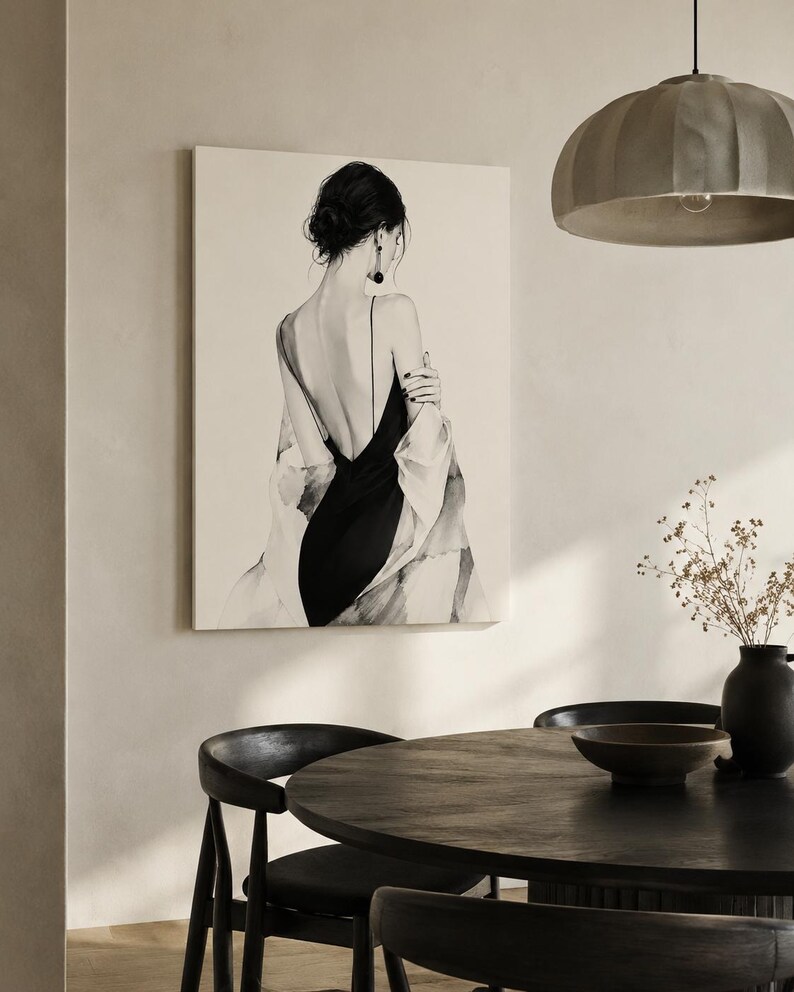 May include: A rectangular wall art print featuring a black and white illustration of a person seen from the back. The figure wears a black dress with thin straps and a low-cut back, draped in a light-colored shawl, with dark hair styled in an updo.