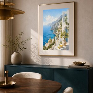 May include: A framed vertical wall art print depicting a coastal Mediterranean scene with white buildings, a golden dome, and a lemon tree in the foreground overlooking a deep blue sea under a bright sky, displayed in a neutral-toned room.