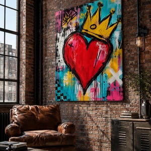 May include: A large rectangular canvas painting featuring a vibrant red heart centered with a bold yellow crown on top. The background is a mix of bright blue, yellow, and pink paint splatters with black brushstrokes and geometric patterns.