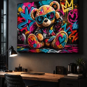 May include: A rectangular canvas wall art print featuring a brown teddy bear wearing blue sunglasses and a dark jacket. The bear is surrounded by vibrant graffiti-style street art including neon pink, blue, and yellow hearts, stars, and crowns.