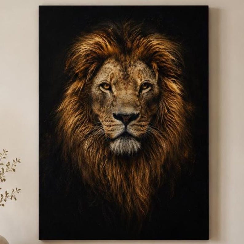 May include: A rectangular wall art print featuring a detailed portrait of a lion with a thick, golden-brown mane. The lion is centered, facing forward with amber eyes, set against a solid, deep black background that highlights its facial features.
