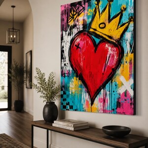May include: A rectangular canvas wall art piece featuring a large, central red heart topped with a yellow crown. The background is a vibrant mix of turquoise, yellow, pink, and black paint splatters, brushstrokes, and abstract geometric shapes.