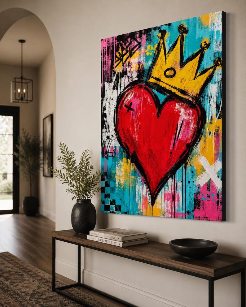 May include: A rectangular canvas wall art piece featuring a large, central red heart topped with a yellow crown. The background is a vibrant mix of turquoise, yellow, pink, and black paint splatters, brushstrokes, and abstract geometric shapes.