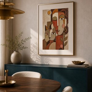 May include: A framed wall art print featuring a stylized cubist-inspired portrait of a person and a cat. The artwork uses a warm color palette of terracotta, beige, and brown tones, with geometric shapes forming the faces and figures.