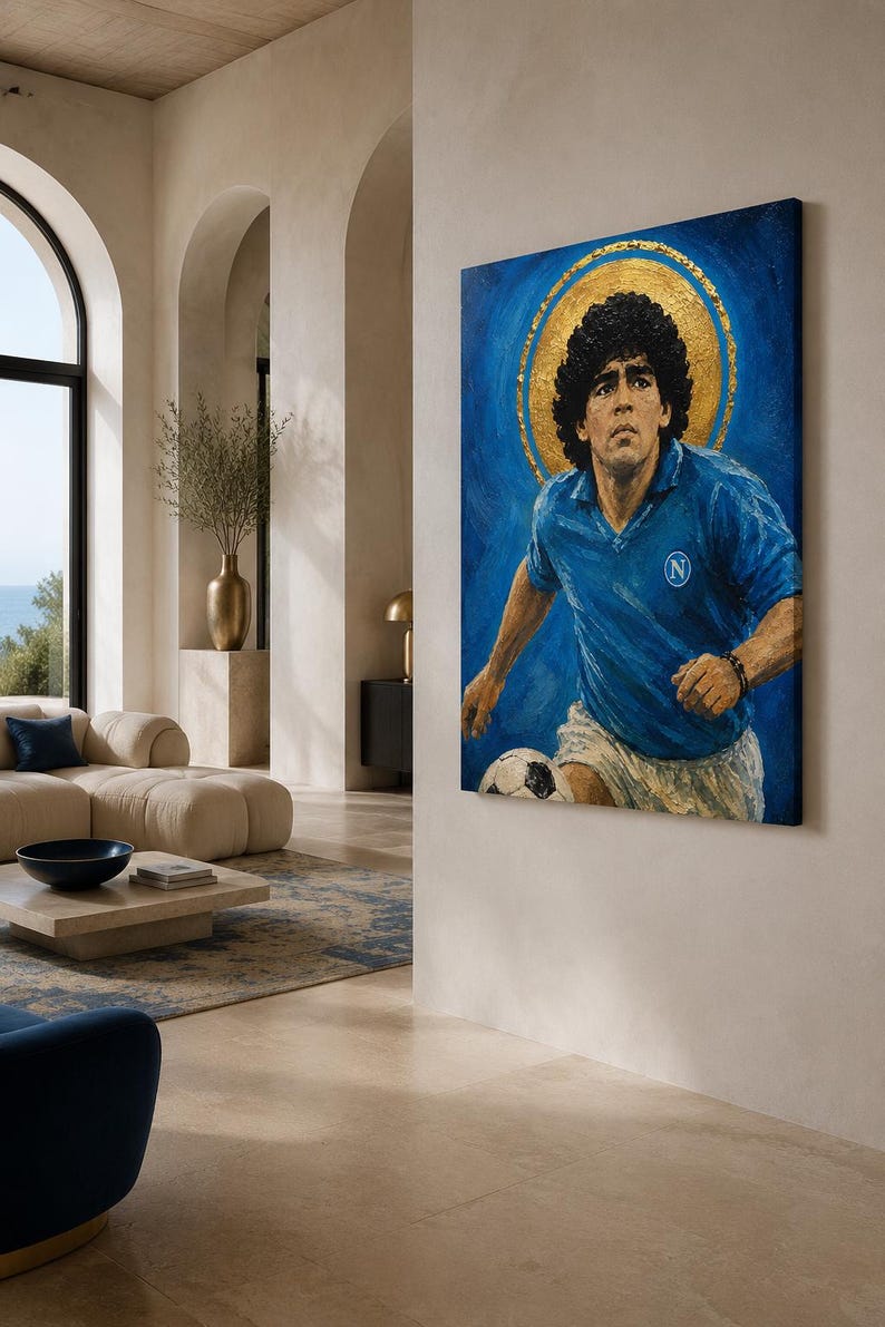 May include: A rectangular canvas painting depicting a soccer player with curly dark hair wearing a blue jersey with a white N logo and white shorts. The player is positioned against a deep blue background with a prominent gold circular halo.