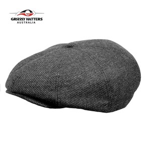 May include: A dark grey newsboy cap made from a textured fabric. The cap has a rounded crown and a short brim.