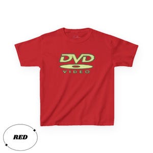 May include: A bright red short-sleeved t-shirt featuring a graphic on the chest. The graphic displays the text DVD VIDEO in a stylized, light-colored font with a disc icon positioned between the two lines of text, centered on the shirt.