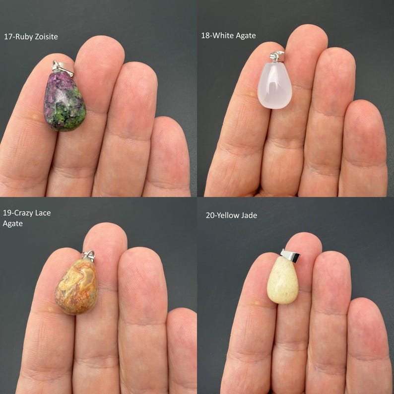 May include: Four teardrop-shaped gemstone pendants with silver-toned bails. The collection includes a mottled green and magenta Ruby Zoisite, a translucent White Agate, a tan and brown patterned Crazy Lace Agate, and a solid pale yellow Jade stone.