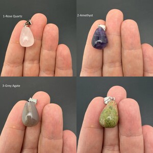May include: Four teardrop-shaped gemstone pendants with silver-toned bails. The collection includes a pale pink rose quartz, a deep purple amethyst, a smooth grey agate, and a mottled green and pink stone, each labeled with its respective name.