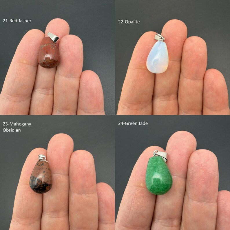 May include: Four teardrop-shaped gemstone pendants with silver-toned bails. The collection includes a reddish-brown Red Jasper, a translucent white Opalite, a dark brown and black Mahogany Obsidian, and a vibrant green Green Jade pendant.