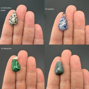 May include: Four teardrop-shaped stone pendants with silver-toned bails. The collection includes a cream and black spotted Dalmatian Jasper, a blue and white Sodalite, a green and black striped Malachite, and a smooth, solid dark green stone pendant.