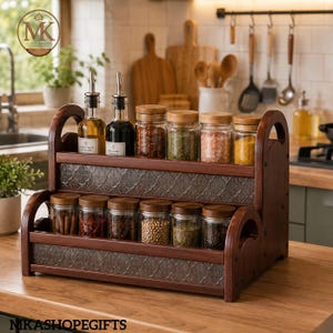 May include: A two-tiered wooden spice rack with a dark finish and embossed metal panels. The rack holds two glass oil bottles with pour spouts and twelve glass jars with wooden lids, filled with various colorful spices, herbs, and seasonings.